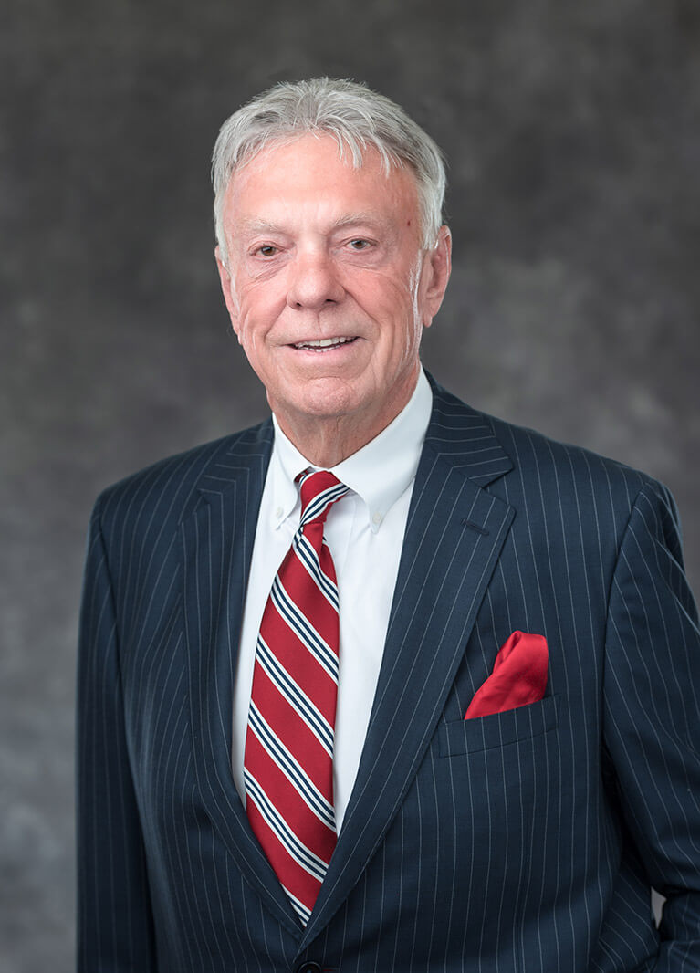 Val Eversgerd wearing a suit with a red and white tie